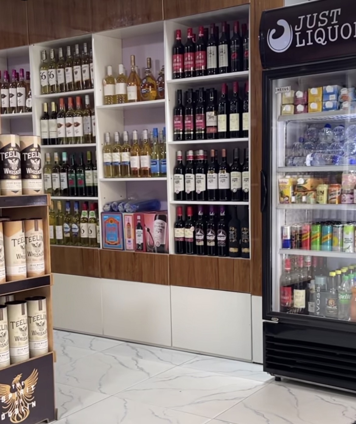 Just Liquor interior — wine and spirits displayed with RetailWings inventory tracking