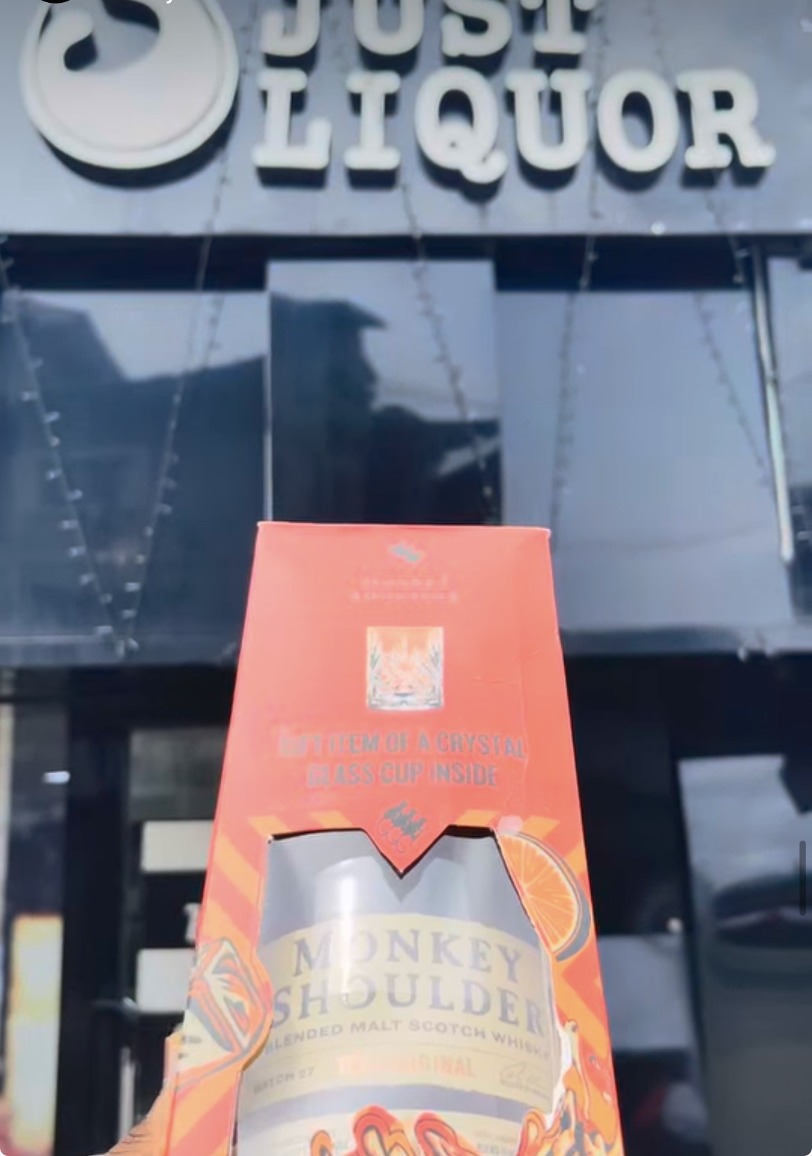 Just Liquor wine and spirits shelves — premium retail display in Lagos