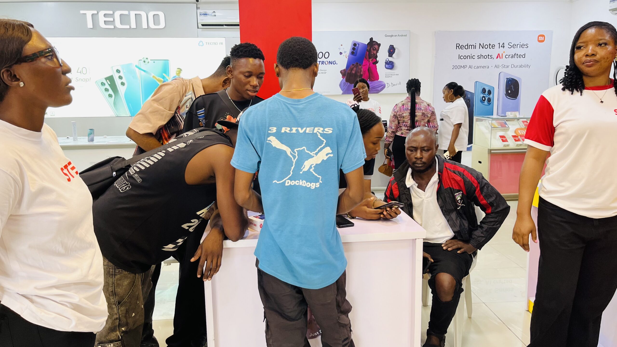 STEL Retail storefront with customers — busy electronics store in Lagos
